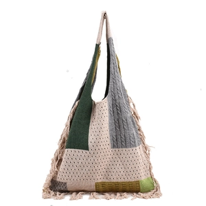 Bohemian patchwork knit tote bag with fringe details in green and beige tones