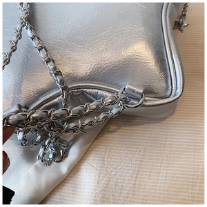 Detailed macro view of the silver star-shaped chain bag with metallic finish and texture