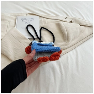 Handmade crochet mini bag with blue and grey knit texture and cute orange duck feet detail
