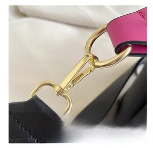 Detailed view of premium gold-plated metal hooks with pink and black leather straps