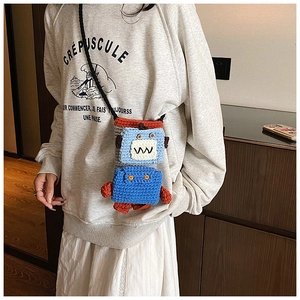 Handmade crochet robot crossbody bag featuring colorful knit textures and button eyes