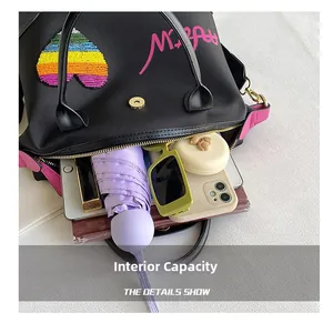 Detail view of black handbag interior showing ample storage for umbrella, phone and makeup