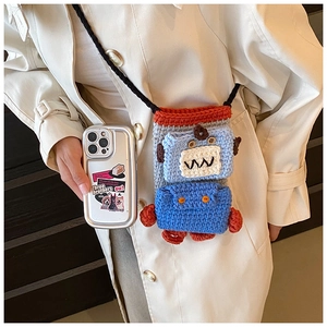 Detail of handmade crochet robot crossbody bag with grey knit and colorful accents