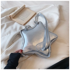 Detailed close-up of silver star-shaped bag with metallic texture and chain strap