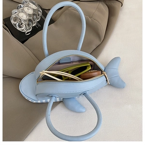Top view of creative whale-shaped blue PU leather handbag with zipper and spacious interior