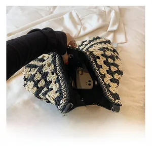 Detail of contrast woven shoulder bag showing interior capacity with phone and lipstick
