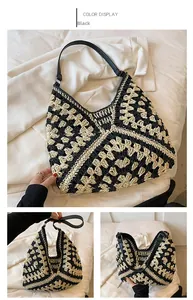 Detail of hand-woven black and white geometric tote bag with sleek black leather straps