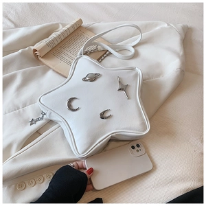 Detailed view of Y2K star-shaped bag with silver planet and moon metal accents
