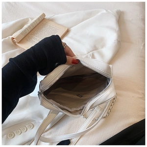Top view of white PU leather crossbody bag showing inner brown lining and zipper pocket