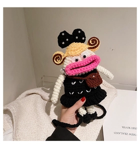 Detailed view of handmade crochet bag with pearl accents and cute bow decoration