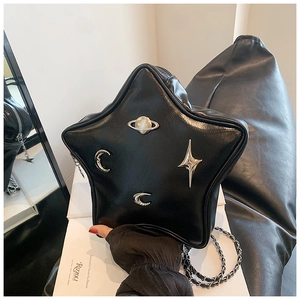 Detailed view of a black star-shaped crossbody bag with metallic planet and moon studs