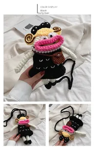 Detail of creative crochet doll crossbody bag with pink lips and pearl necklace