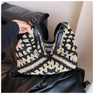 Detail of contrast color woven tote bag with geometric hollow pattern and leather strap
