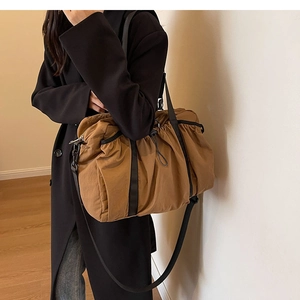Detailed view of brown nylon shoulder bag with stylish drawstring pleated cloud texture
