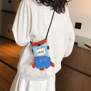 Handmade crochet robot crossbody bag in blue and orange yarn for a quirky style
