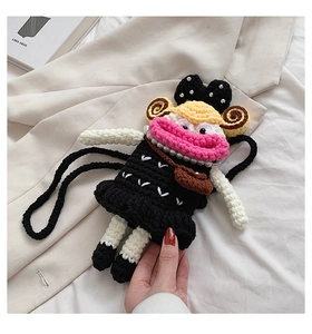 Detailed knit of a creative crochet doll bag featuring pink big lips and yellow curls