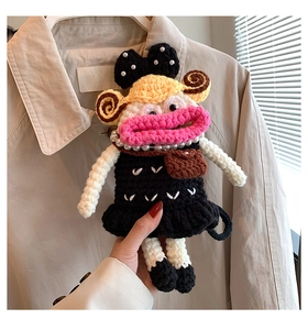Handcrafted crochet doll charm with pearl bow and black dress accessory detail