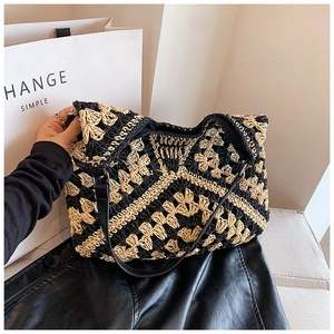 Detail of hand-crocheted geometric flower pattern on the black and beige tote bag