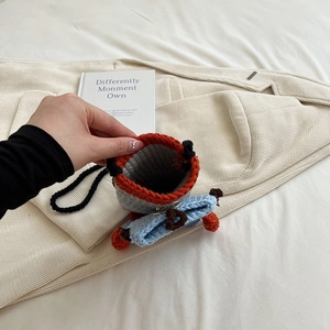Handmade crochet crossbody bag in orange and blue knit design with black strap