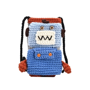 Handmade crochet monster knit shoulder bag with blue yarn and wooden button eyes