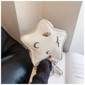 Detail of star-shaped PU leather bag featuring silver planet and moon metal accents