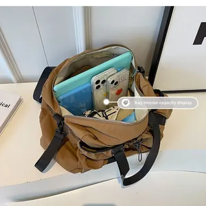 Detail view of large nylon functional bag interior holding a tablet and two smartphones