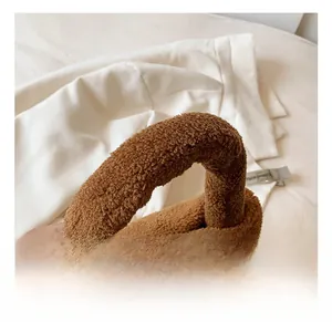 Detail view of the plush brown faux fur handbag handle with a soft fleece texture