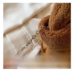 Detailed macro view of the brown plush faux shearling and leather bucket bag materials