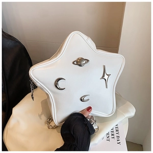 Macro shot of white star-shaped PU leather bag with silver planetary metal studs