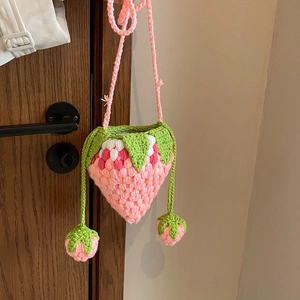 Handmade crochet strawberry crossbody bag with pink yarn and green leaf detail