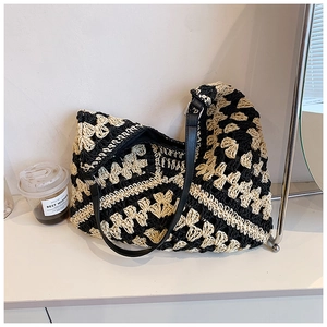 Close-up of hand-woven crochet tote bag showing black and white geometric lattice texture