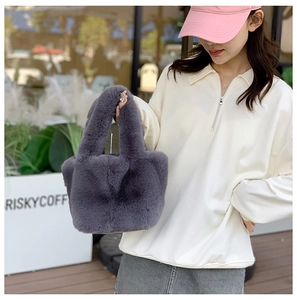 Detailed texture of dark grey faux fur tote bag featuring unique handle design