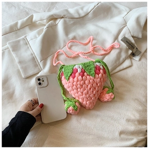 Handmade strawberry crochet crossbody bag with pink yarn knit and leaf detail