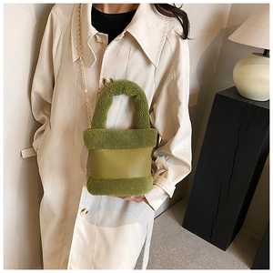 Detail of avocado green plush and leather crossbody bucket bag with gold chain strap