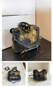 Detailansicht der Denim-Tasche mit Vintage-Waschung, Fransen und Schnürung im Retro-Look