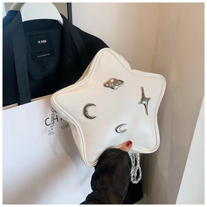 Detail of white star-shaped Y2K crossbody bag with silver metallic planet and moon logos