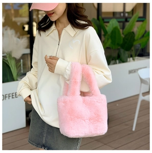 Close-up of soft pink faux fur handbag with plush texture for winter fashion
