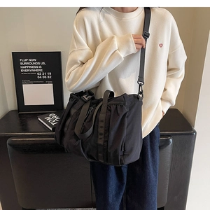 Detailed view of black nylon functional bag with adjustable strap and buckle hardware
