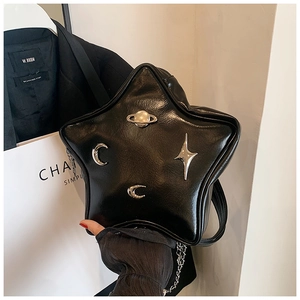 Detail of star-shaped crossbody bag with cosmic silver metal ornaments and chain strap