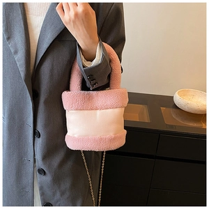 Pink plush faux fur bucket bag with leather patchwork and gold chain strap detail