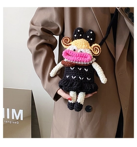 Detail of handmade crochet crossbody bag with oversized lips and heart knit dress pattern