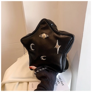 Detail of star-shaped black PU leather crossbody bag with silver celestial charms