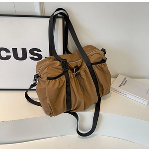 Close-up of camel nylon tote bag with drawstring texture and black functional buckle