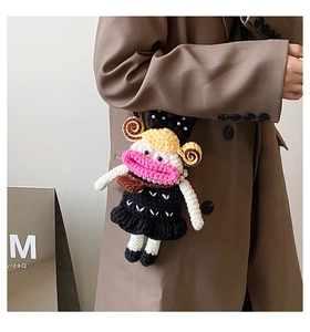 Fashionable handmade crochet doll bag charm featuring quirky blonde twin tails on a model