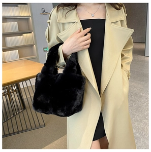 Close-up of black faux fur tote bag with plush texture and wide top handles for autumn