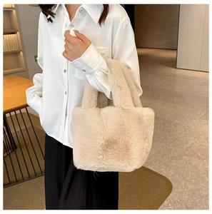 Close-up of fluffy cream plush tote bag showing soft faux fur texture and sturdy handles