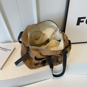 Large brown nylon functional crossbody bag with internal storage compartments for travel