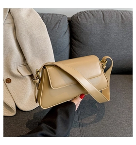 Detail of khaki square shoulder bag with smooth leather finish and retro gold hardware
