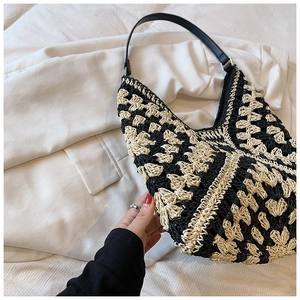 Detail of hand-woven black and white crochet patterns on summer bohemian shoulder bag