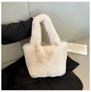 Detail of soft cream plush handbag showing its fluffy texture and comfortable handle